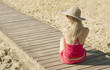 girl sitting back on track by the sea