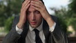 Video: Portrait of depressed businessman in the park, close up Portrait of depressed businessman in the park, close up