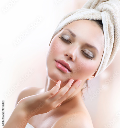 Photo: Spa Girl. Beautiful Young Woman After Bath Touching Her Face Spa Girl. Beautiful Young Woman After Bath Touching Her Face