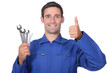 plumber holding wrenches all smiles