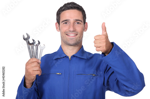 Photo: plumber holding wrenches all smiles plumber holding wrenches all smiles