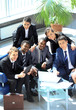 Satisfied proud business team looking at camera an