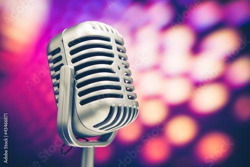 Photo: retro microphone on purple disco background retro microphone on purple disco background