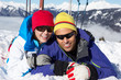 Couple Having Fun On Ski Holiday In Mountains