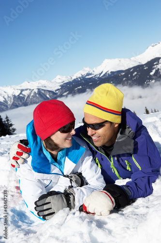 Photo: Couple Having Fun On Ski Holiday In Mountains Couple Having Fun On Ski Holiday In Mountains