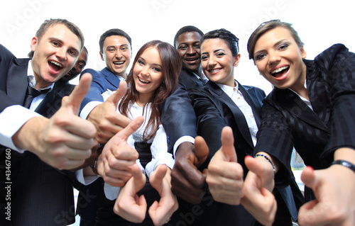 Photo: Happy multi-ethnic business team with thumbs up in Happy multi-ethnic business team with thumbs up in