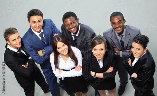 Photo: Top view of business people with their hands together Top view of business people with their hands together