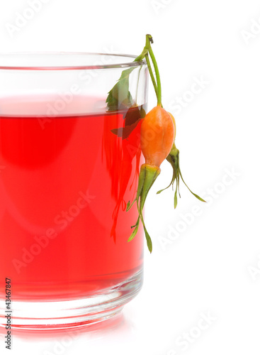 Photo: cup of tea from the berries of wild rose on a white background cup of tea from the berries of wild rose on a white background