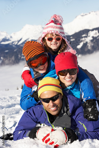 Photo: Family Having Fun On Ski Holiday In Mountains Family Having Fun On Ski Holiday In Mountains