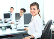 Happy young businesswoman looking behind and