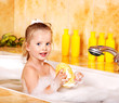 Child washing in bubble bath .