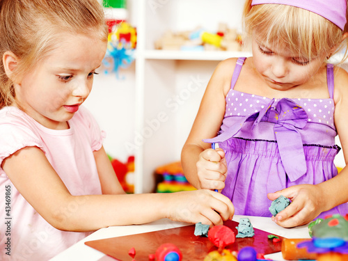 Photo: Child playing plasticine. Child playing plasticine.