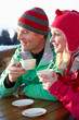 Couple Enjoying Hot Drink In Café At Ski Resort