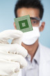 Scientist showing a microchip computer