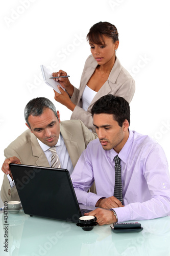 Photo: Sales team working on laptop Sales team working on laptop
