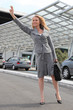 Businesswoman waving taxi