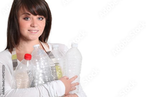 Photo: Young woman taking out the recycling Young woman taking out the recycling