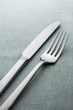 knife and fork on a neutral background