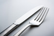 knife and fork on a neutral background