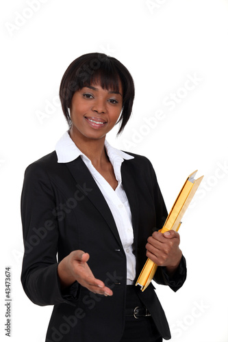 Photo: A black businesswoman about to give a handshake. A black businesswoman about to give a handshake.