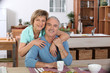 Middle-aged couple having breakfast together in kitchen