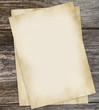 Old edged paper on wood