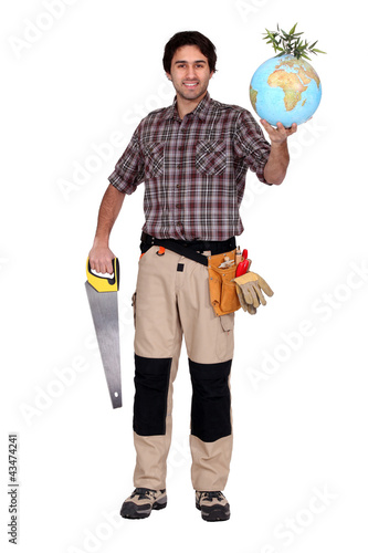 Foto : Man holding saw and globe Man holding saw and globe