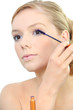 Woman applying mascara