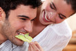 A couple sharing food.