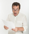 Scared man reading a document