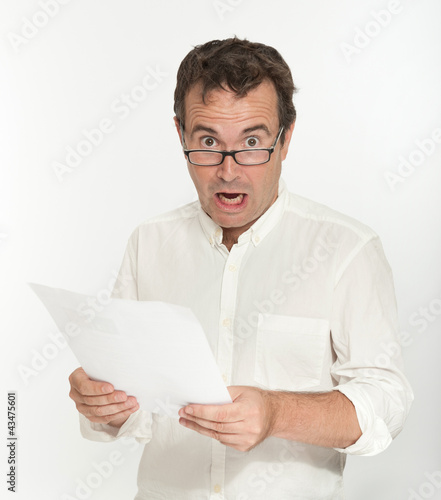 Photo: Scared man reading a document Scared man reading a document