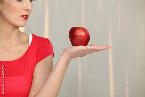 Photo: Woman holding an apple Woman holding an apple