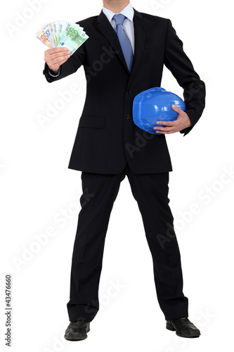 Photo: Builder holding wedge of bank notes Builder holding wedge of bank notes
