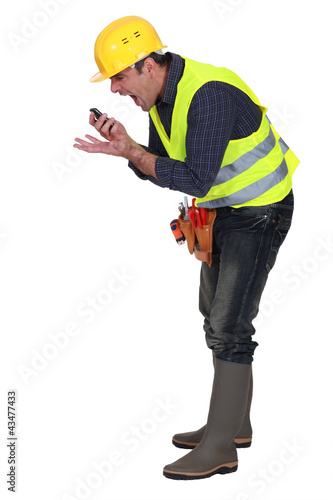 Photo: foreman screaming in a mobile phone foreman screaming in a mobile phone