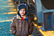 Boy hobo homeless tramp bum on street freezing close to railway