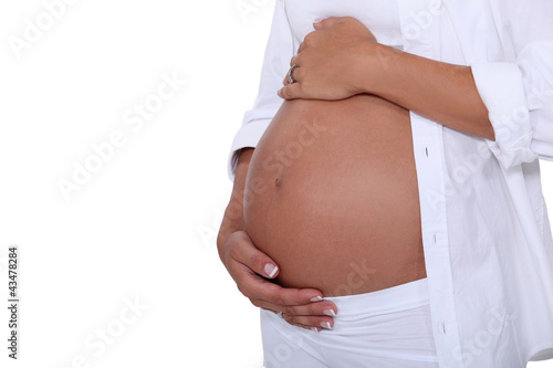 Photo: Pregnant woman holding her tummy Pregnant woman holding her tummy