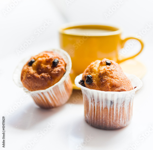 Photo: Coffee in an yellow cup and muffins Coffee in an yellow cup and muffins