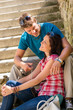 Couple smiling at each other on stairs