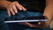 A woman with tablet on legs (close-up)