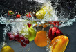Fruit and vegetables splash into water