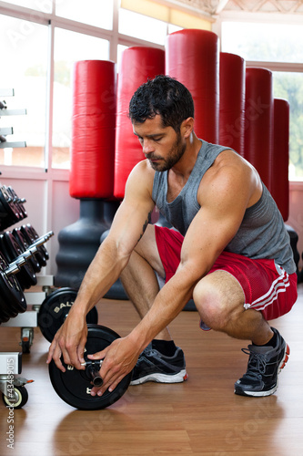 Photo: Handsome muscular man at the gym. Handsome muscular man at the gym.