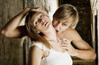 Male vampire bites a blonde woman