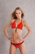 A young blond Caucasian woman posing in a red swimsuit