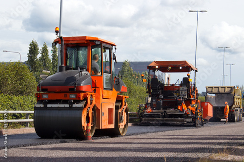 Photo: Asphalt roller and pavement machine in use Asphalt roller and pavement machine in use