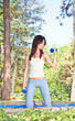 Young woman doing  gym exercises in the park