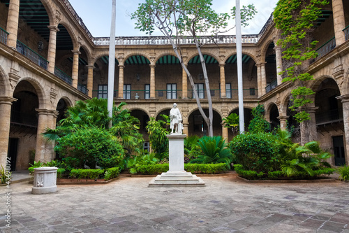 Spanish colonial palace in Old Havana with a statue of Columbus