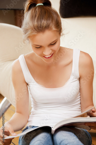 Photo: happy and smiling teenage girl with magazine happy and smiling teenage girl with magazine
