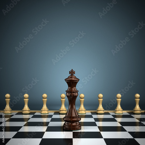 Photo: King with pawns on chessboard symbolizing leadership or battle King with pawns on chessboard symbolizing leadership or battle