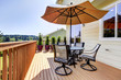 Deck with table, chairs and umbrella.