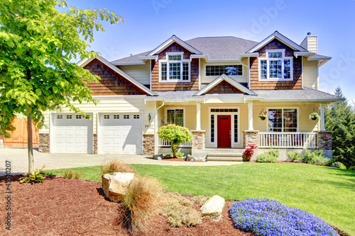 Photo: Large American beautiful house with red door. Large American beautiful house with red door.